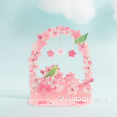 Greeting card -cherry blossoms arch and bird heralding spring-