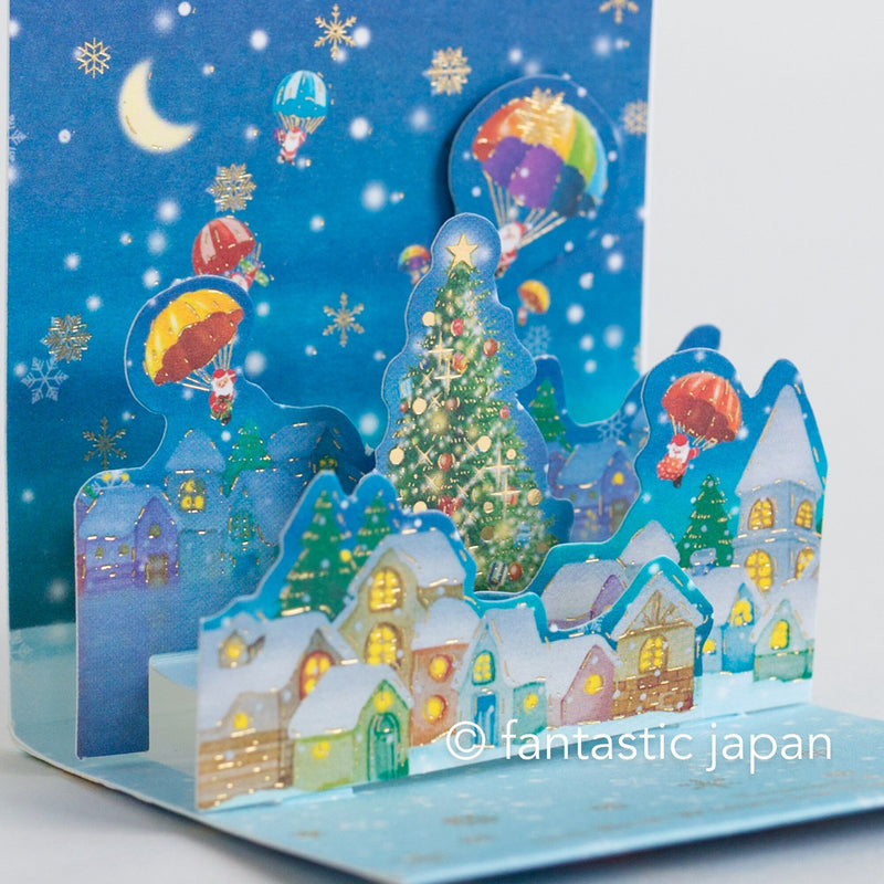 Christmas tiny pop up card -mini mini Santa Clauses parachuting into town-