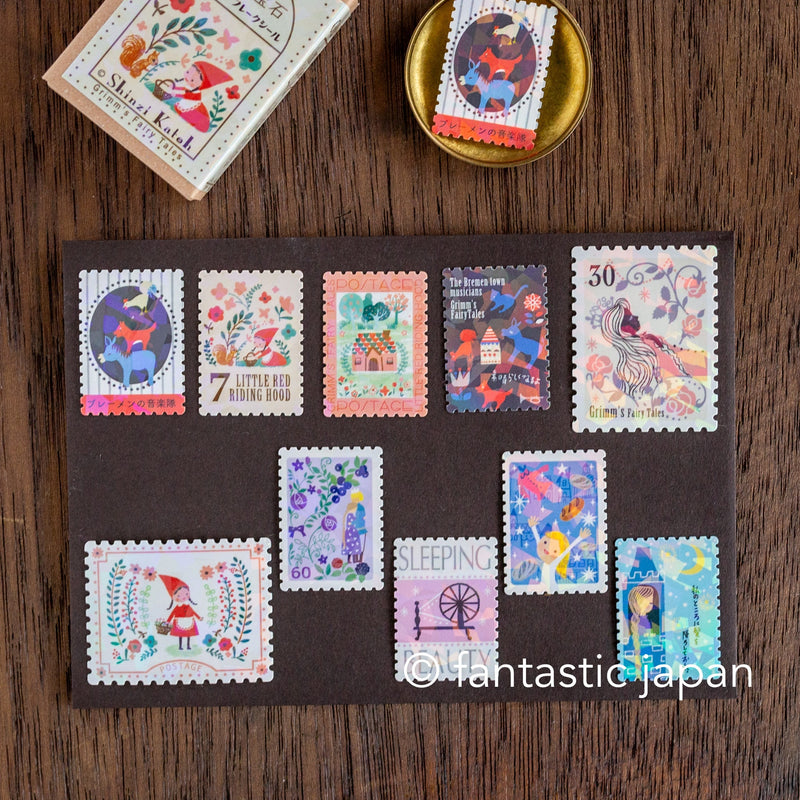 Postage flake stickers in a match box -Grimm&