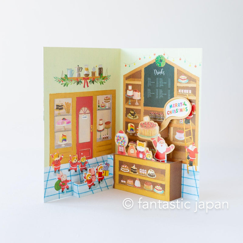 Christmas pop up card -Santa Clauses in the candy shop-