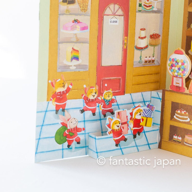 Christmas pop up card -Santa Clauses in the candy shop-