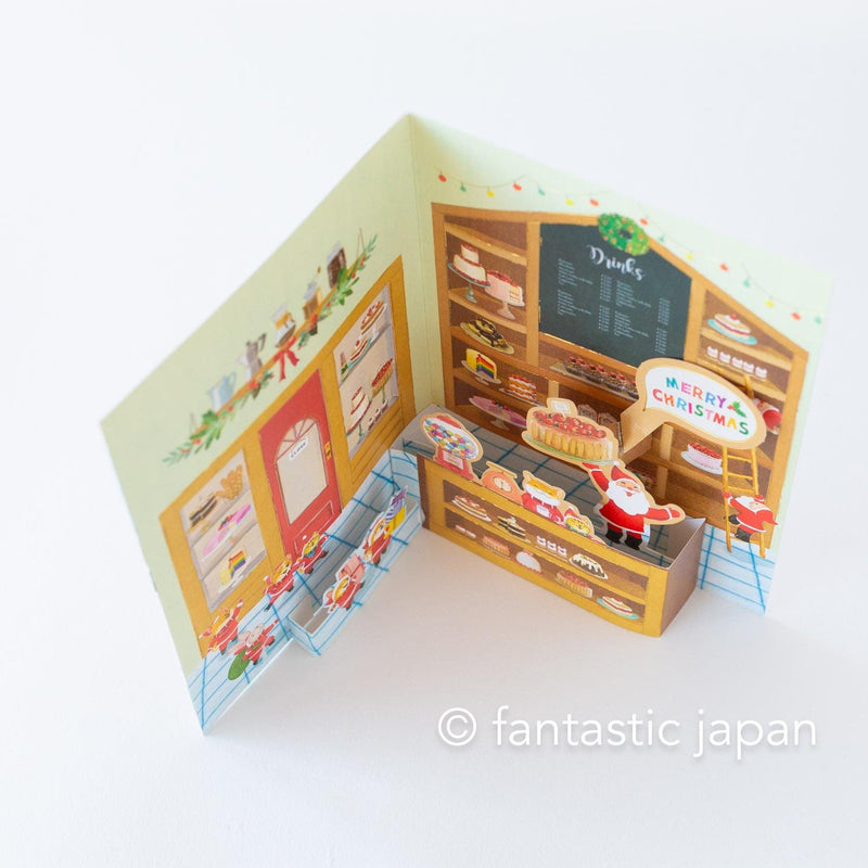 Christmas pop up card -Santa Clauses in the candy shop-