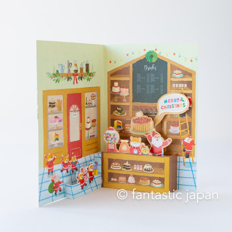 Christmas pop up card -Santa Clauses in the candy shop-