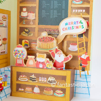 Christmas pop up card -Santa Clauses in the candy shop-