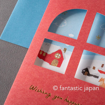 Greeting card with window -A snowy landscape and a cottage-