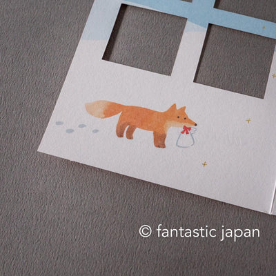 Greeting card with window -A snowy landscape and a cottage-