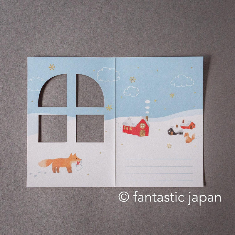 Greeting card with window -A snowy landscape and a cottage-