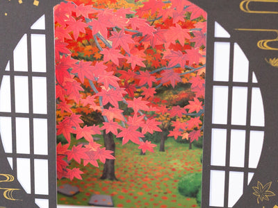 Greeting card -Autumn leaves through a traditional circle window-