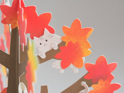 Greeting card "Autumn greeting -cat playing on the red leaf tree-