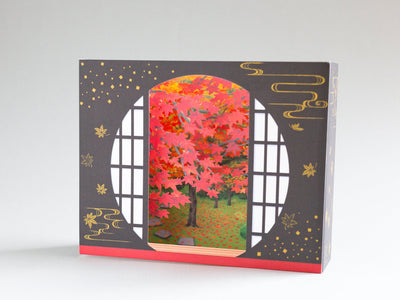 Greeting card -Autumn leaves through a traditional circle window-