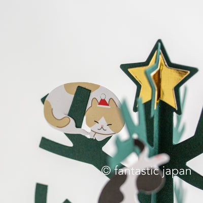 Christmas card -cat playing on the Christmas tree-
