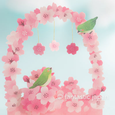 Greeting card -cherry blossoms arch and bird heralding spring-
