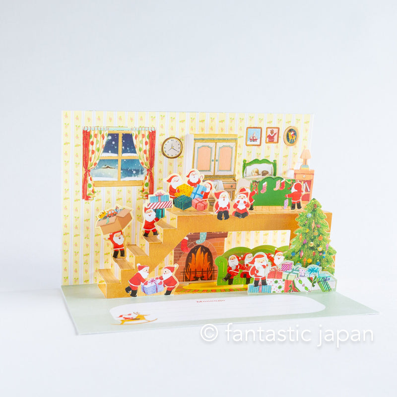 Christmas pop up card -Santa Clauses relaxing in the house-