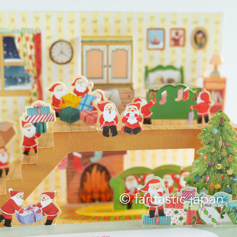 Christmas pop up card -Santa Clauses relaxing in the house-