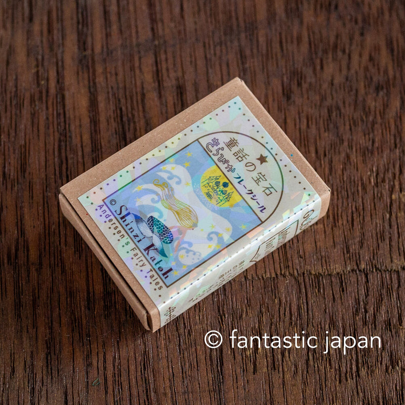 Postage flake stickers in a match box -Andersen&