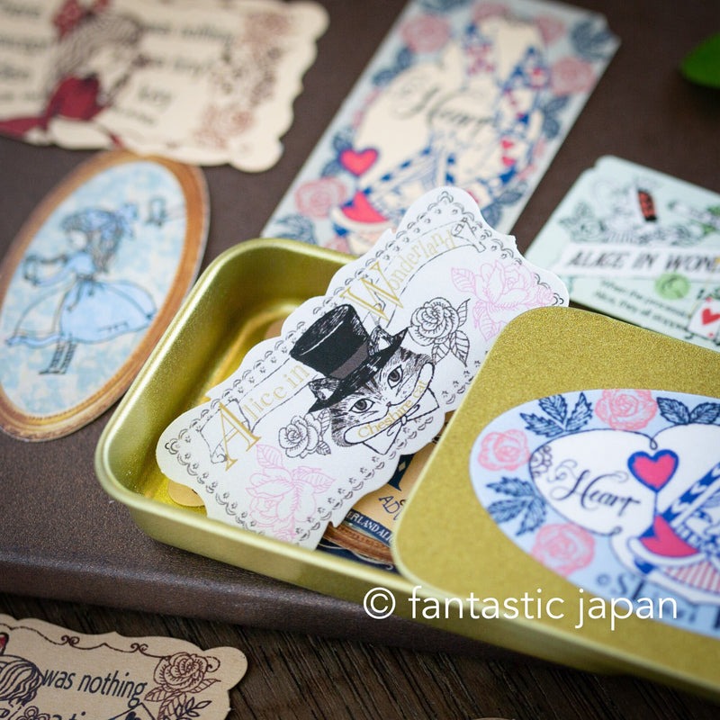 Flake stickers in a small tin box / Alice&